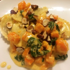 Mushroom ravioli with roasted butternut squash, hazelnuts and spinach in a cream sauce