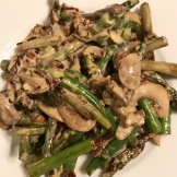 Mushrooms and asparagus tossed in Insane Sauce